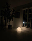 sandstone sea urchin lamp on floor lighting up a dark room at night