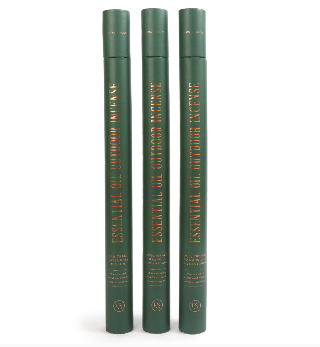 3 tall green cylindrical boxes with large punk incense sticks in three different scents
