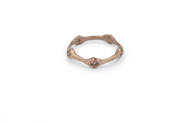 rose gold band ring with bone detail set with white diamonds