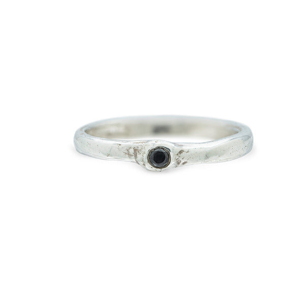 silver ring with barnacle detail holding black diamond on white background