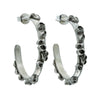 Pair of silver barnacle encrusted hoop earrings with black accents on a white background