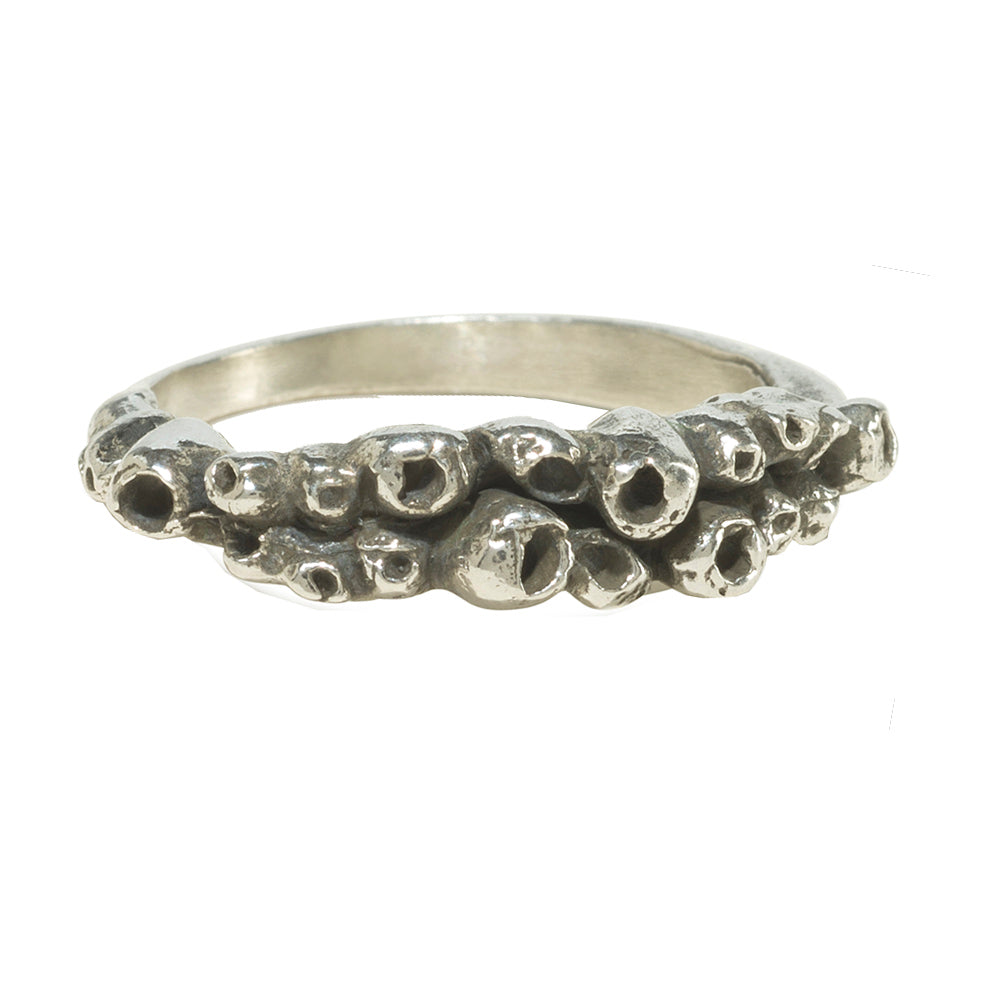 barnacle details on silver ring on white background