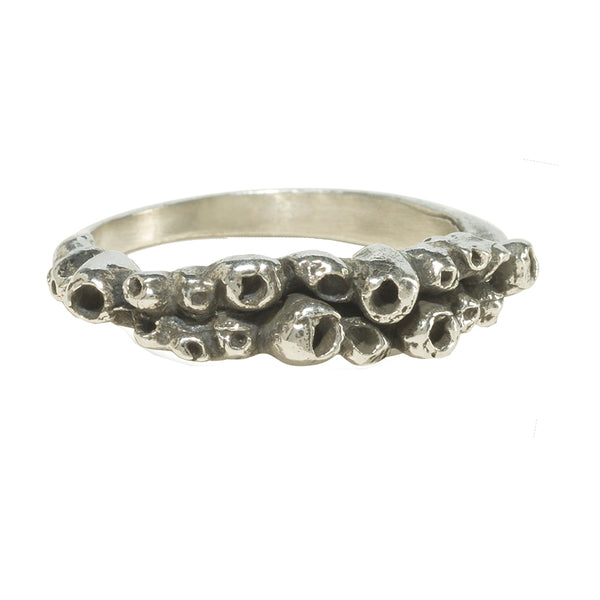 barnacle details on silver ring on white background