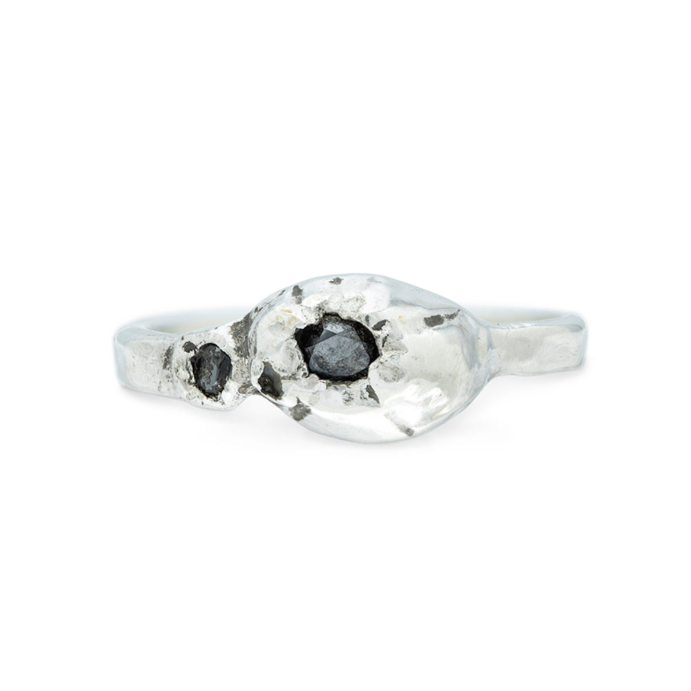 silver ring with big and small barnacle detail set with black diamonds on a silver band