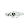 silver ring with big and small barnacle detail set with black diamonds on a silver band