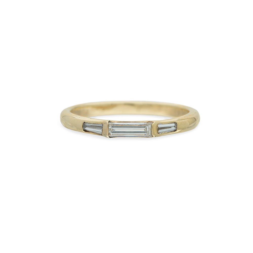 baguette diamonds in a gold ring on white background