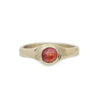 Gold ring with around  red amber stone on a white background