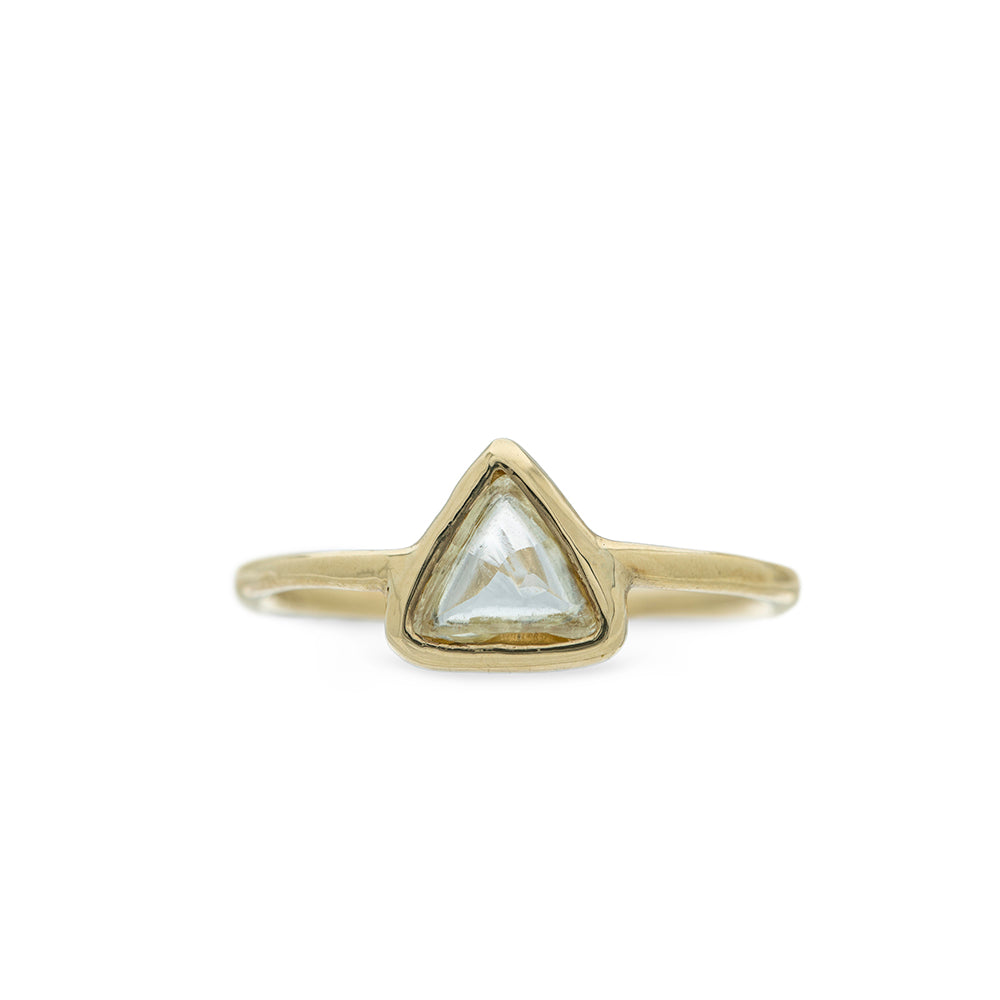 Gold ring with a triangle-shaped macle diamond on a white background