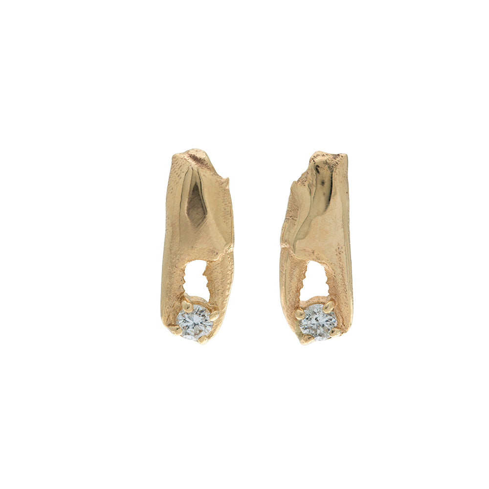 gold crab pincer earrings holding little diamonds on white background
