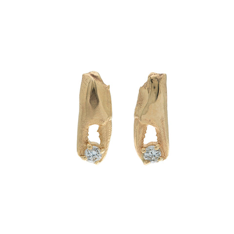 gold crab pincer earrings holding little diamonds on white background
