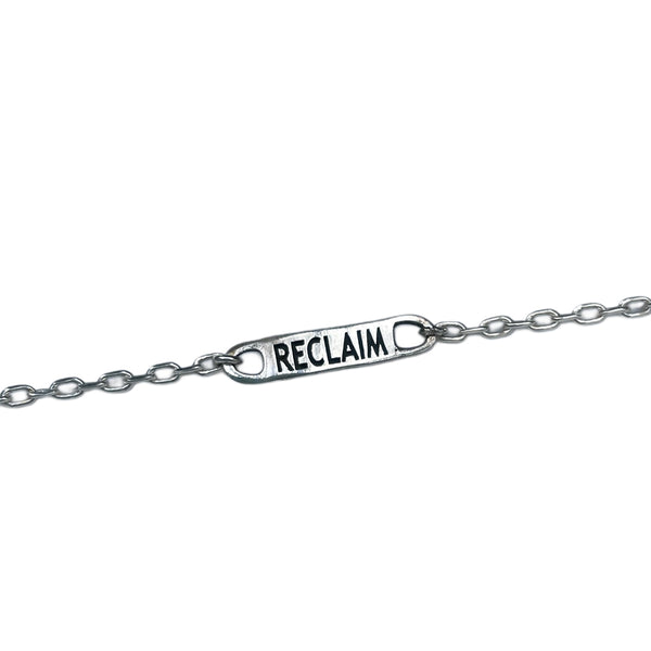 Silver chain with a 'RECLAIM' tag on a white background