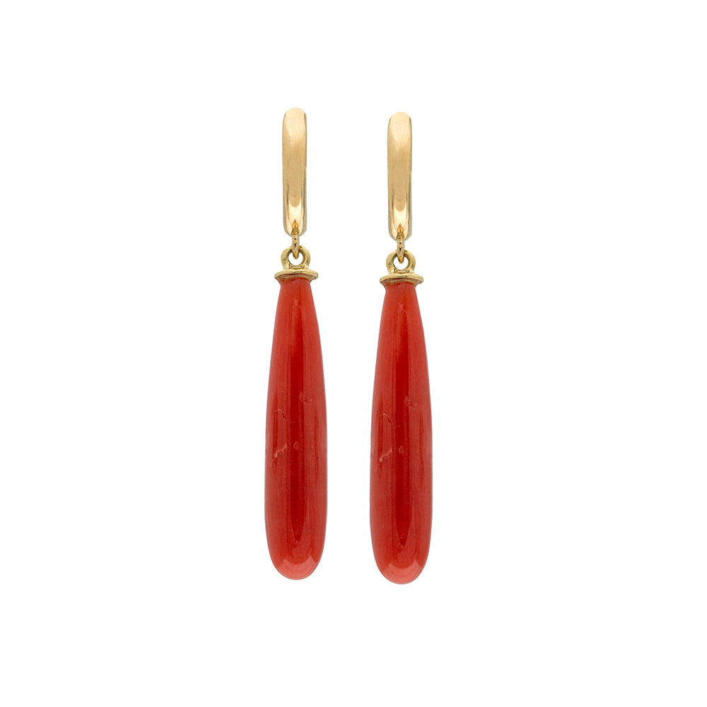 Pair of gold earrings with brown red coral drops on a white background
