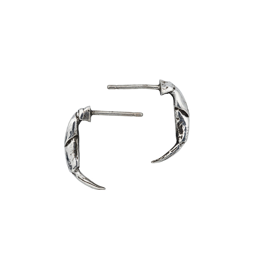 Little silver crab pincer earrings pointing left and right.