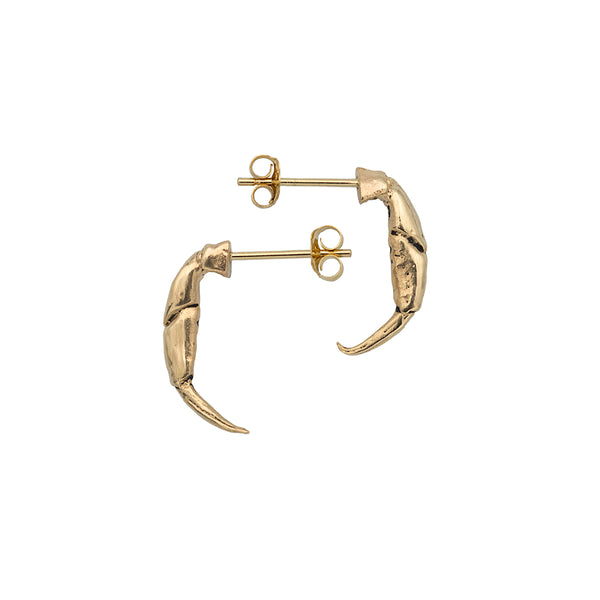 A pair of gold crab pincers as stud earrings pointing left anad right.
