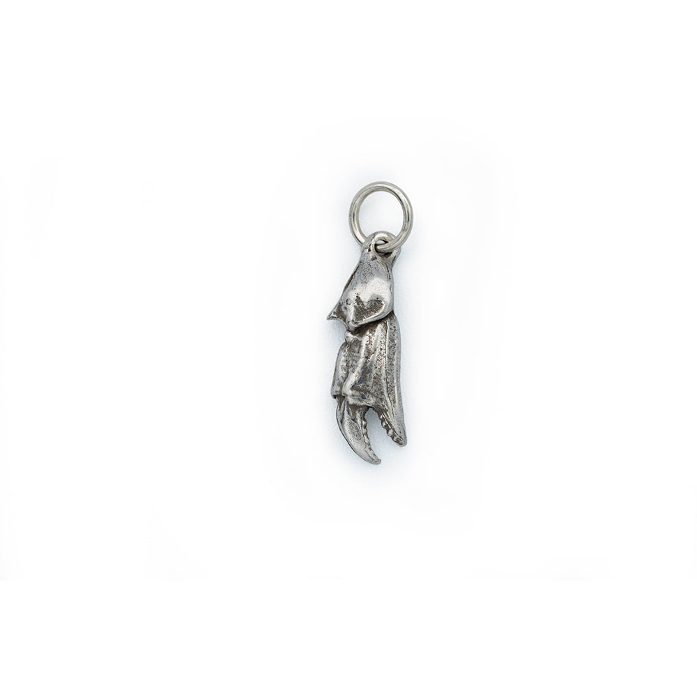 A silver crab claw with antique detail hanging from a silver jump ring.