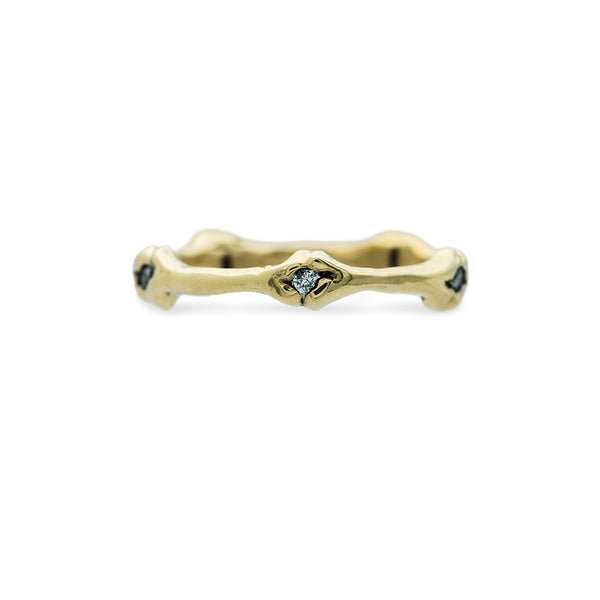 gold band ring with bone detail set with diamonds in between