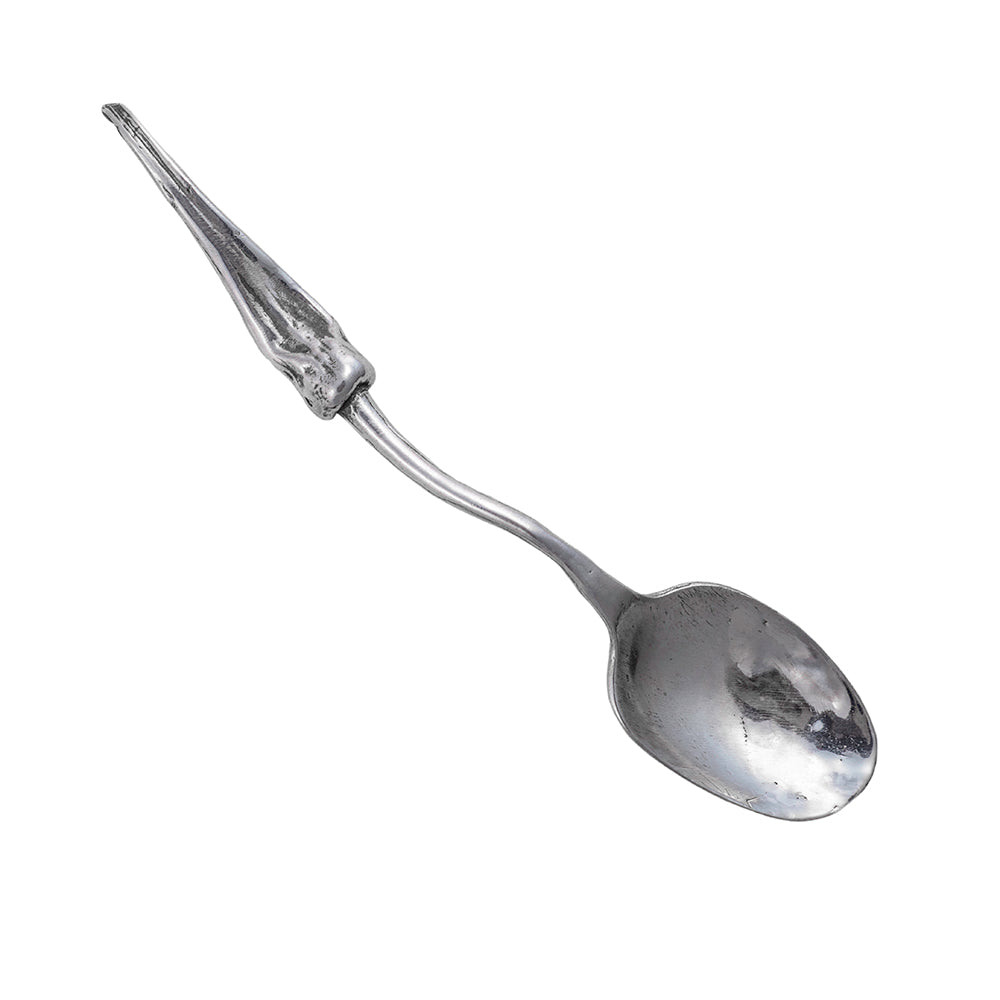 A silver spoon with garlic scape handle.