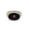 A gold ring set  with an oval black onyx.  Inside the black onyx is a small round ruby set in gold.