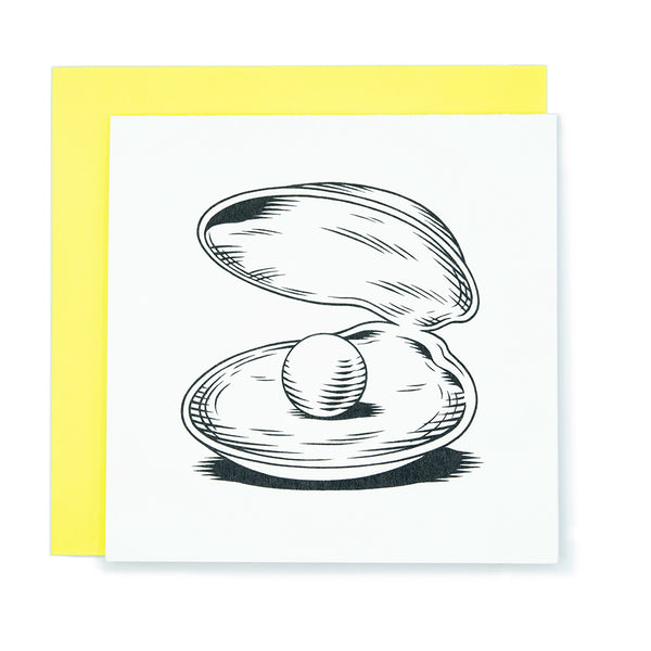 A square greeting card with an illustration of a giant pearl inside a clam shell.