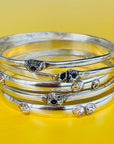 stack of silver barnacle bracelets