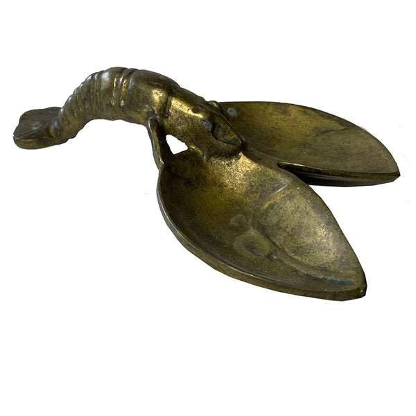 bronze lobster dish on white background

