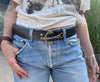 A model shot of girl wearing belt with bronze anchor buckle in blue jeans