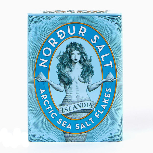 Nordur Salt Arctic Sea Salt Flakes packaging with a stylized illustration of a woman on a blue background.