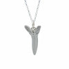 A Silver shark tooth necklace on a white background