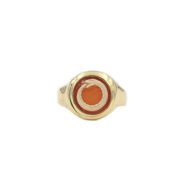 gold ring holding cameo of a serpent biting its tail