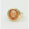 side view of gold ring with skeleton cameo