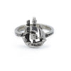 A silver ring featuring a sculpted sailing ship atop the band.