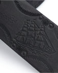 detail of ship on hand stamped black leather belt