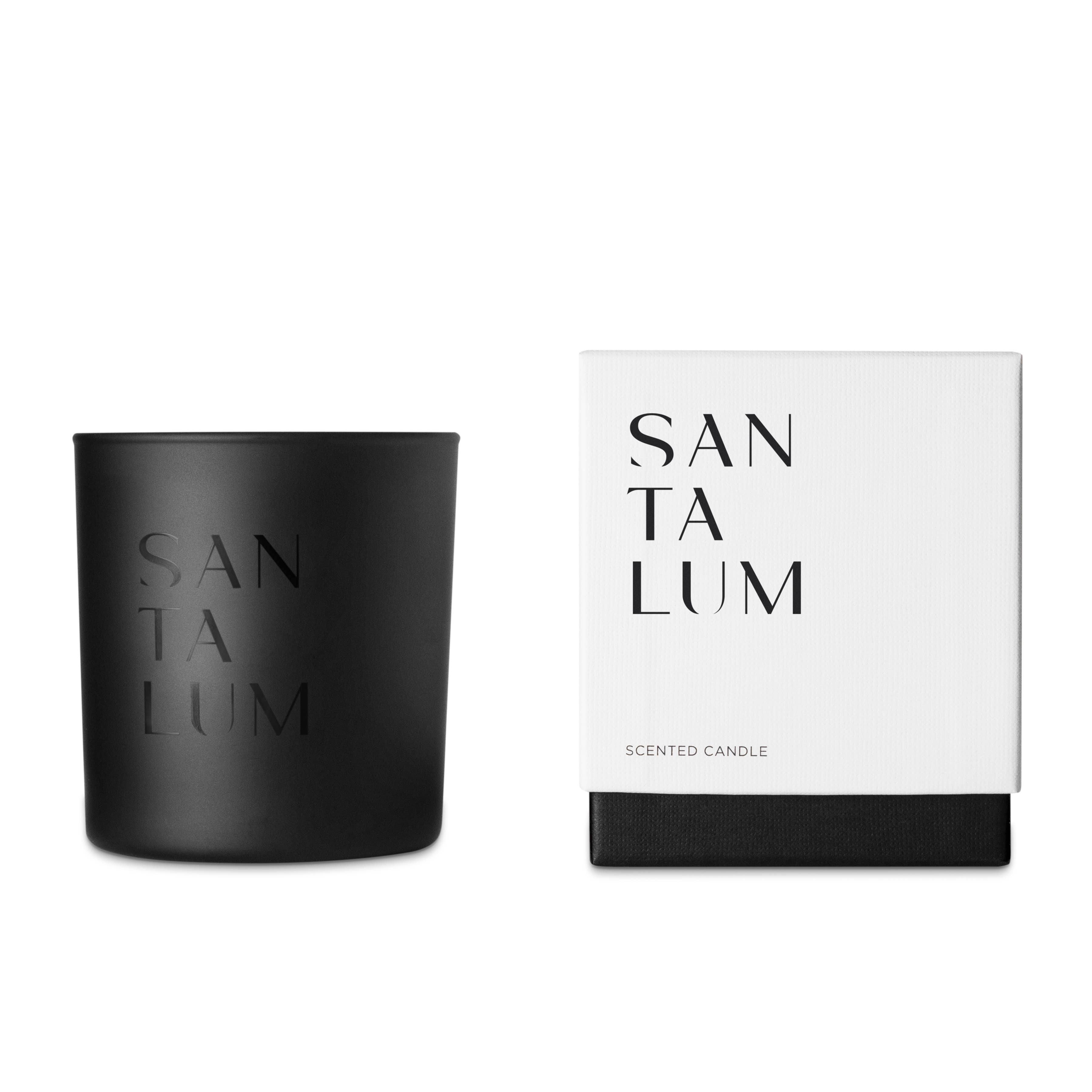 black glass candle and white box that says santalum