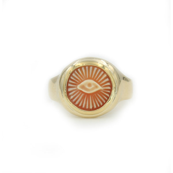gold ring holding cameo stone carved with an all seeing eye with rays coming from it