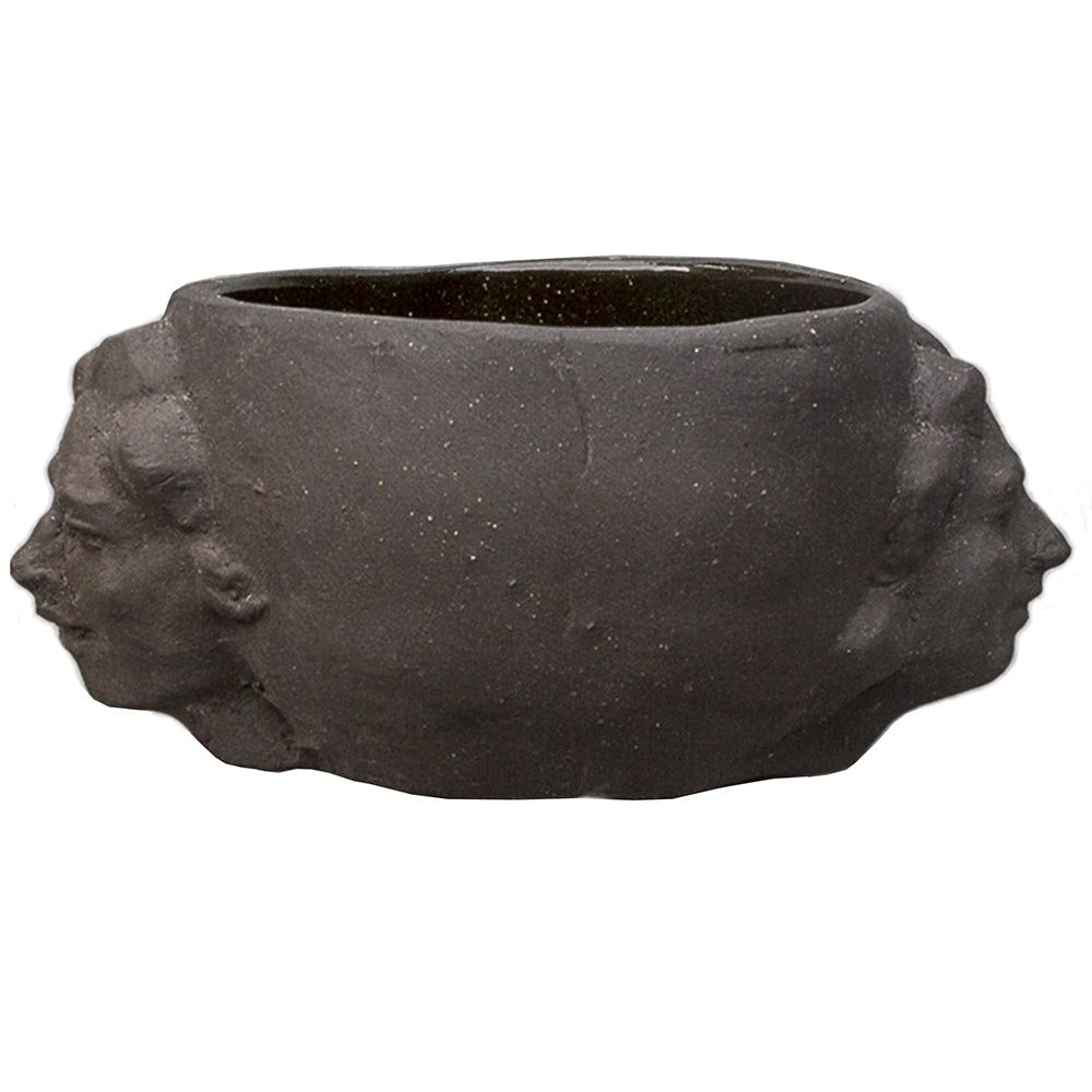 matte black hand built drinking vessel with two figureheads on each side