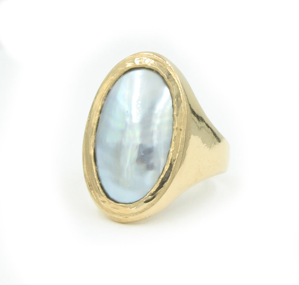 A long gold oval ring set with a metallic grey osmena pearl.