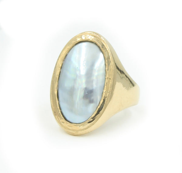 A long gold oval ring set with a metallic grey osmena pearl.