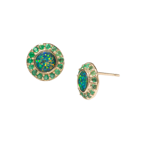 Round gold earrings with center stone a blue opal surrounded by small round green emeralds.