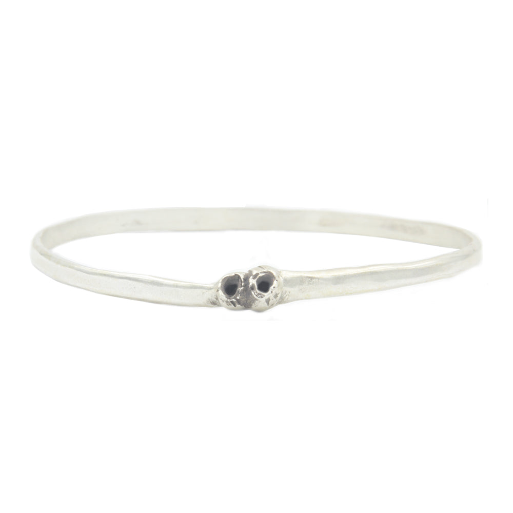 A round silver bangle style bracelet with two silver barnacle details.