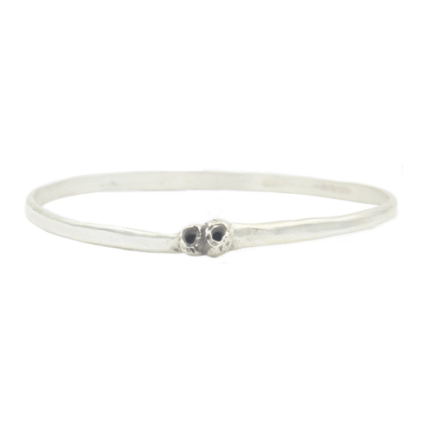A round silver bangle style bracelet with two silver barnacle details.