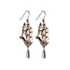Pair of polished bronze earrings in the shape of ships with teardrop shaped pearl dangles handing from ship bottom.