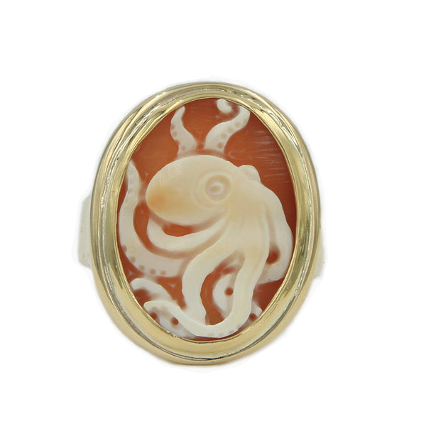 A gold ring holding cameo carved with octopus.