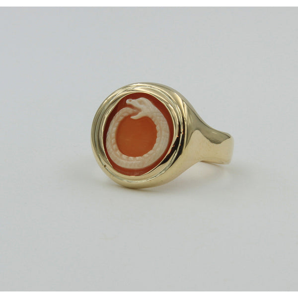 side view of gold ring holding cameo with carving of snake biting its tail