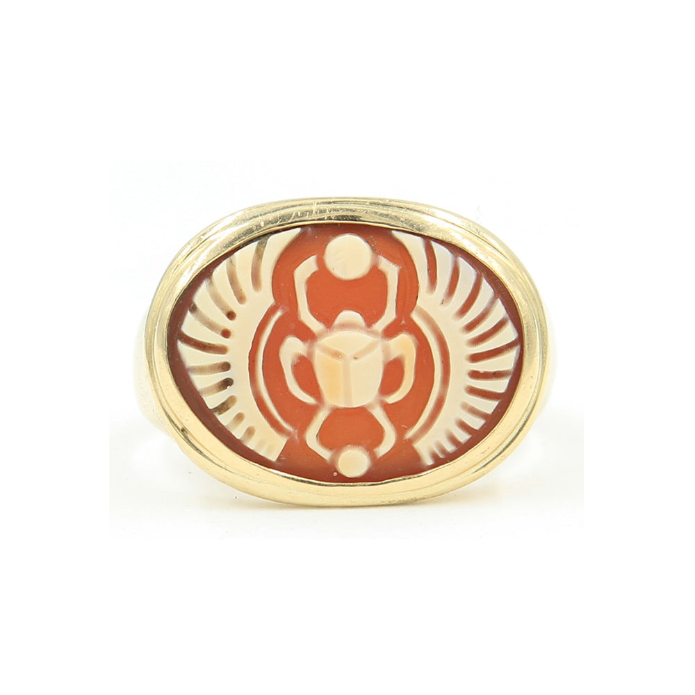 A gold ring set with cameo carved with a scarab.