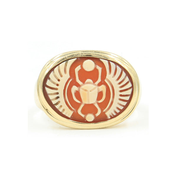 A gold ring set with cameo carved with a scarab.