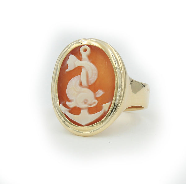 A side view of gold ring with sea dolphin and cameo carved in cameo shell.