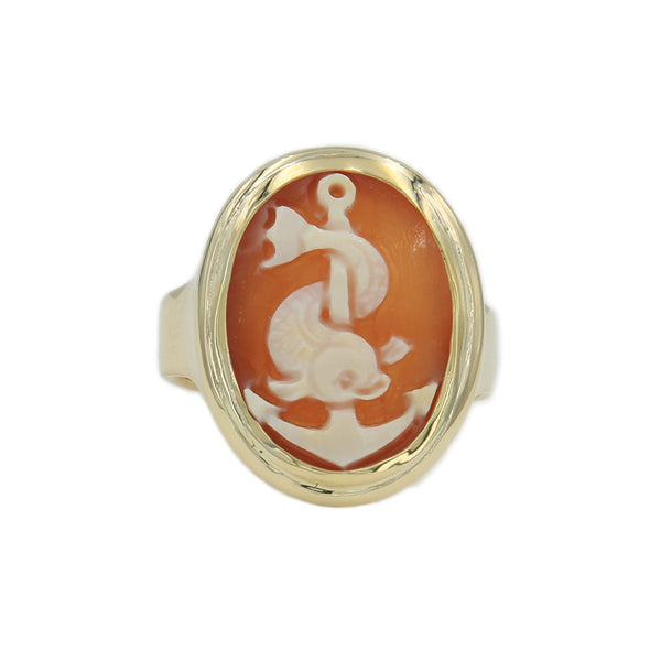 A gold cameo ring with sea dolphin and anchor carved in cameo shell.