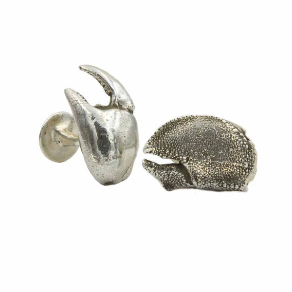 A pair of silver cufflinks that are two different lobster claws.  One is a smooth left claw and one is textured.