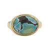 Gold Ring featuring an oval turquoise stone with marbling.A gold ring featuring a sculpted sailing ship atop the band.