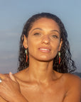 model in water wearing chrysopras and coral earrings